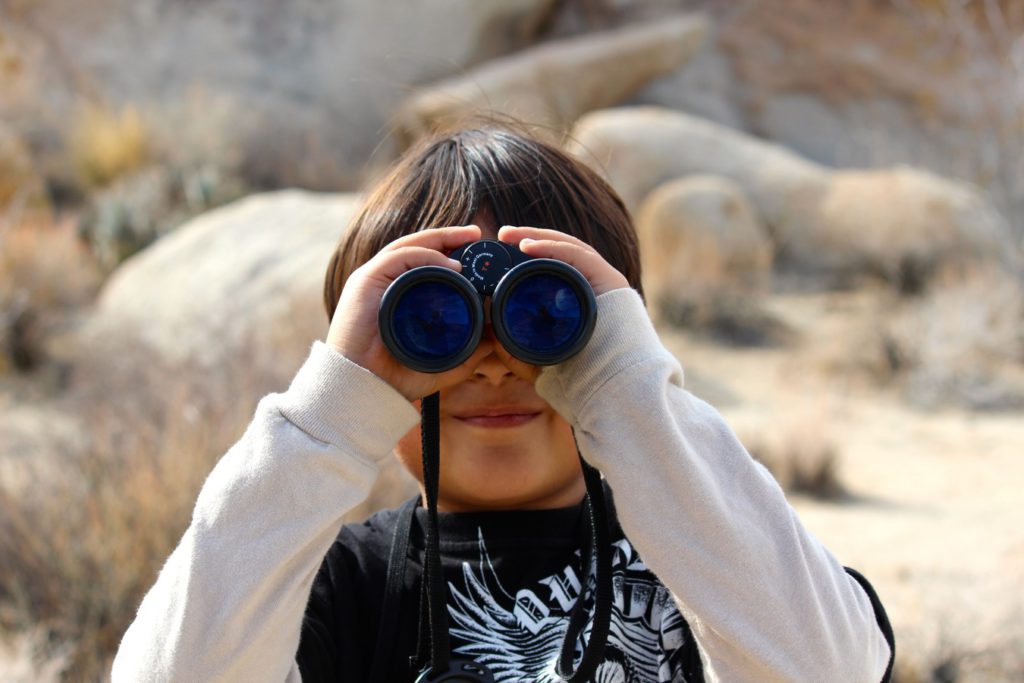 looking for things as a boy with binoculars